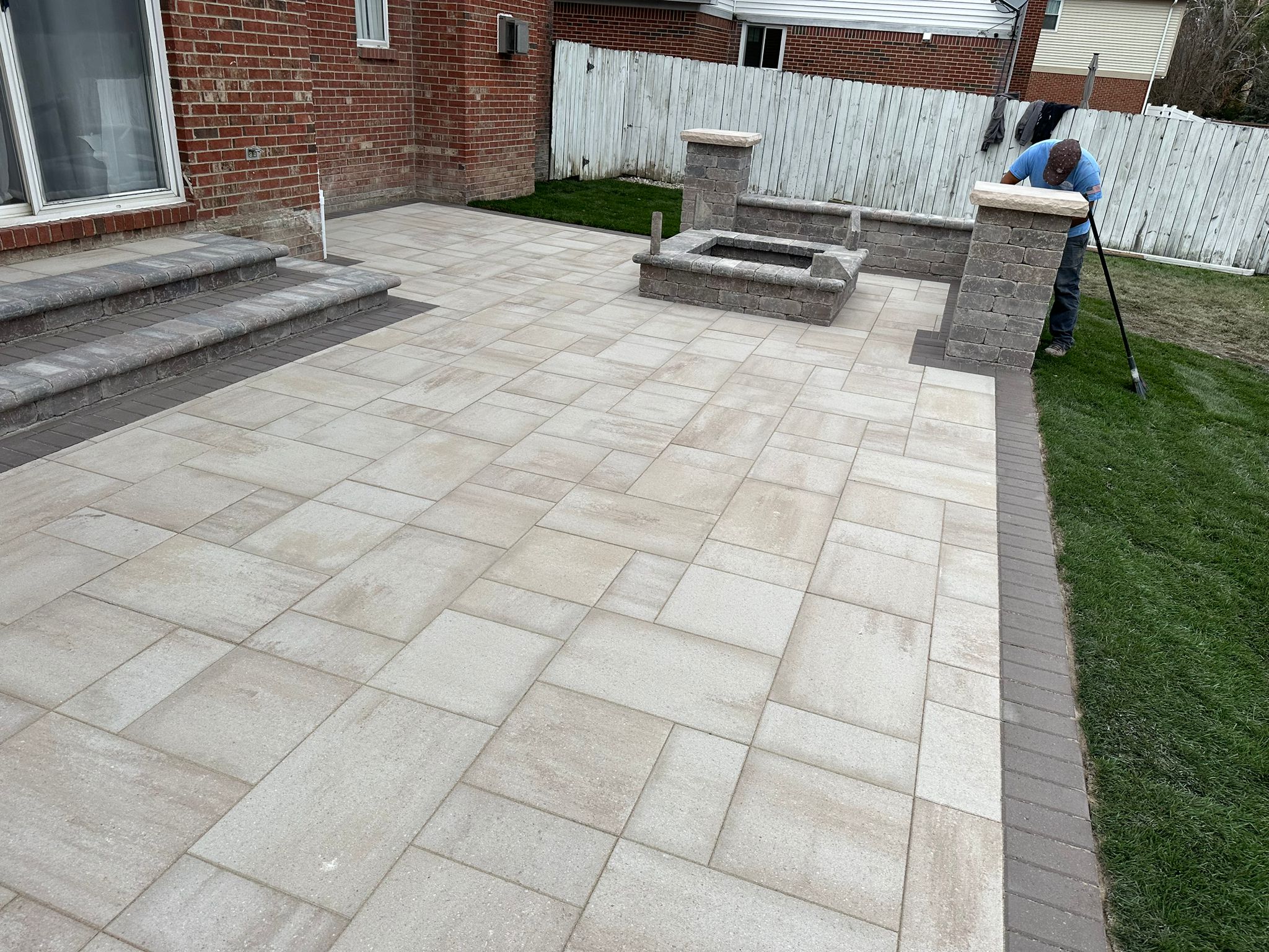 Large patio with fire pit and seating wall